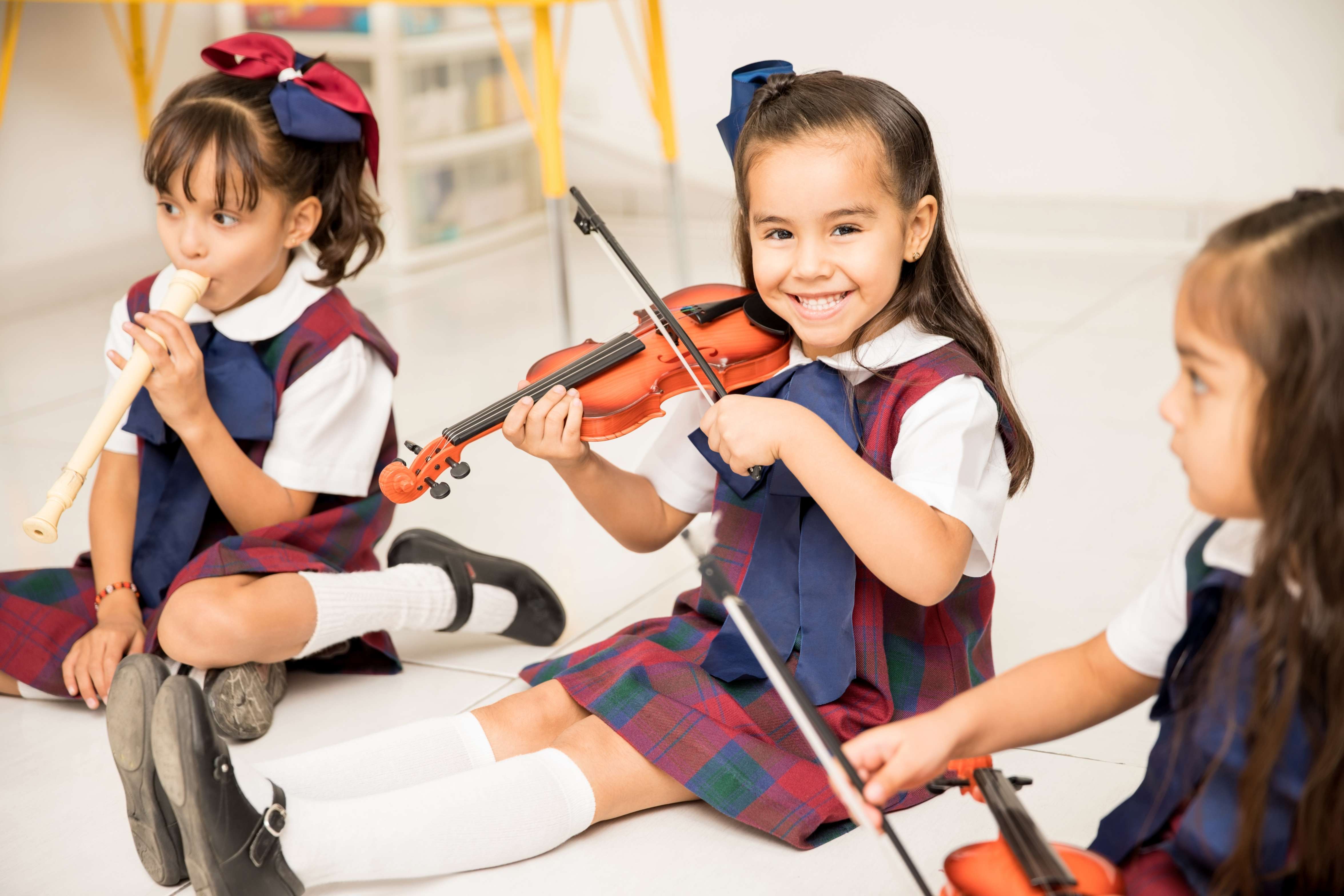Children dancing and playing instruments during music and movement session