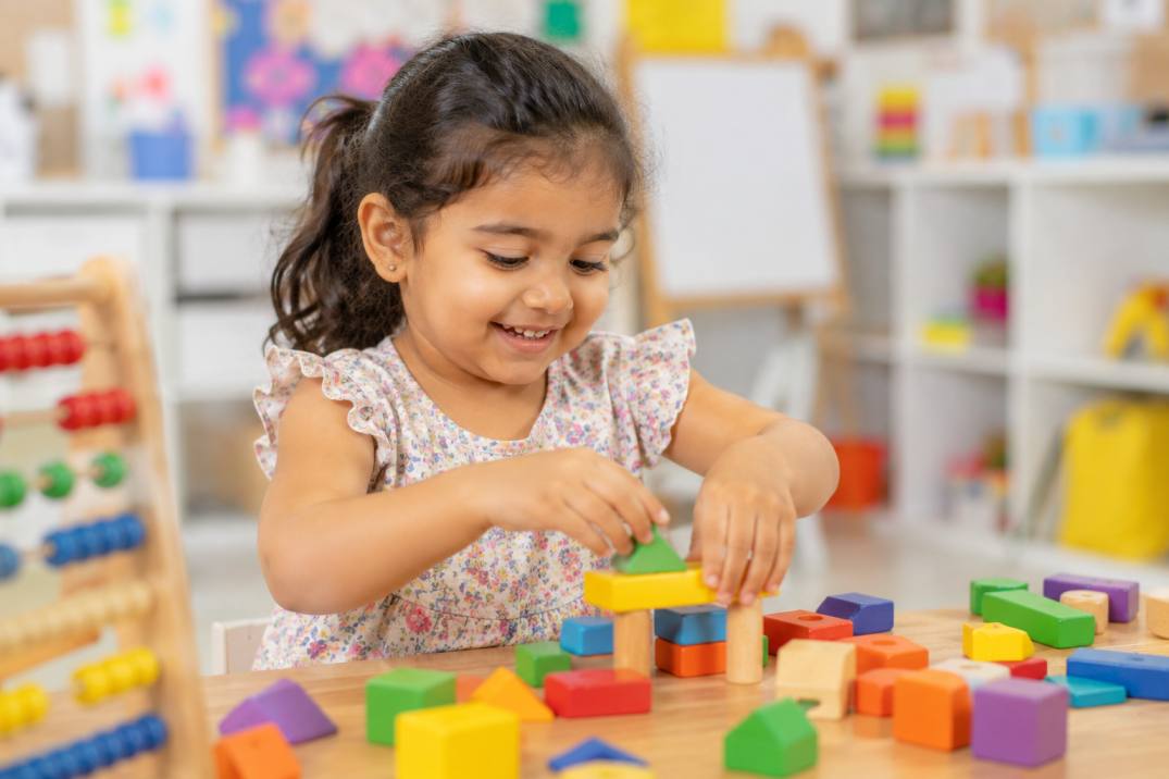 Child concentrating on a colourful puzzle activity