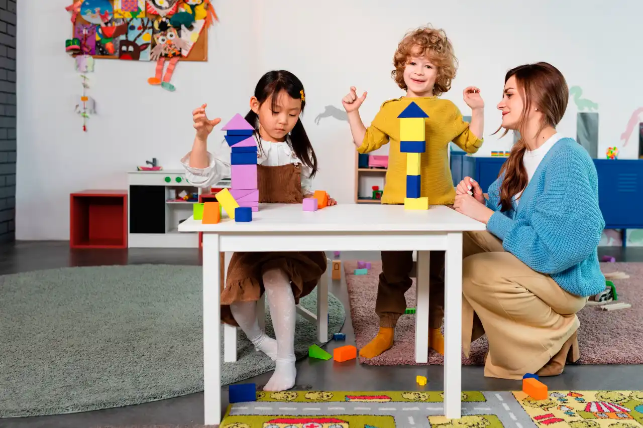 Teacher guiding children in a hands-on learning activity at Sprouting Munchkins
